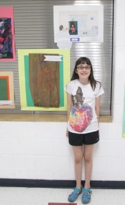 Jordan with some of her artwork on display at school