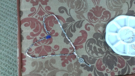My new heart shaped clasp end for my necklace. One side is blue, the other is silver =)