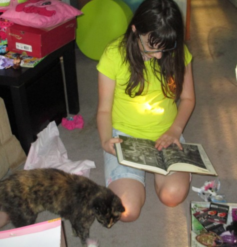 Flipping through her new Xanth guide with Avi wandering through...